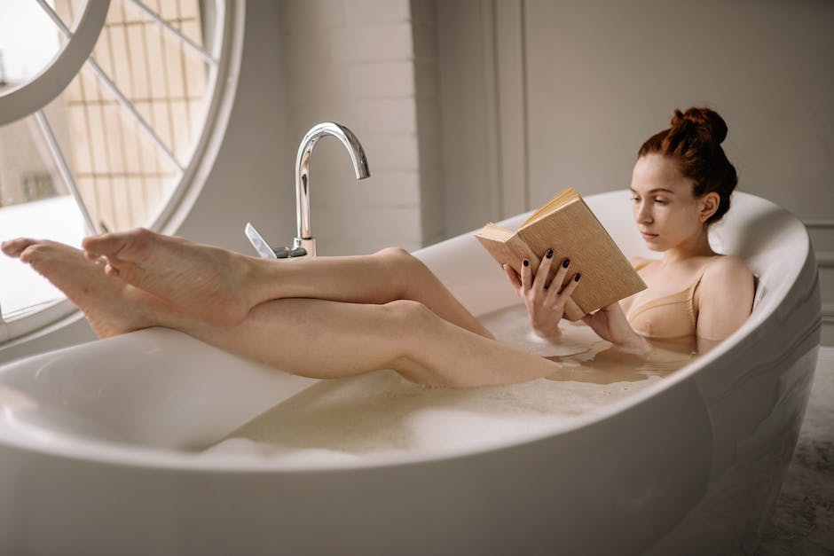 A woman enjoying a relaxing bath in a beautifully designed bathroom.