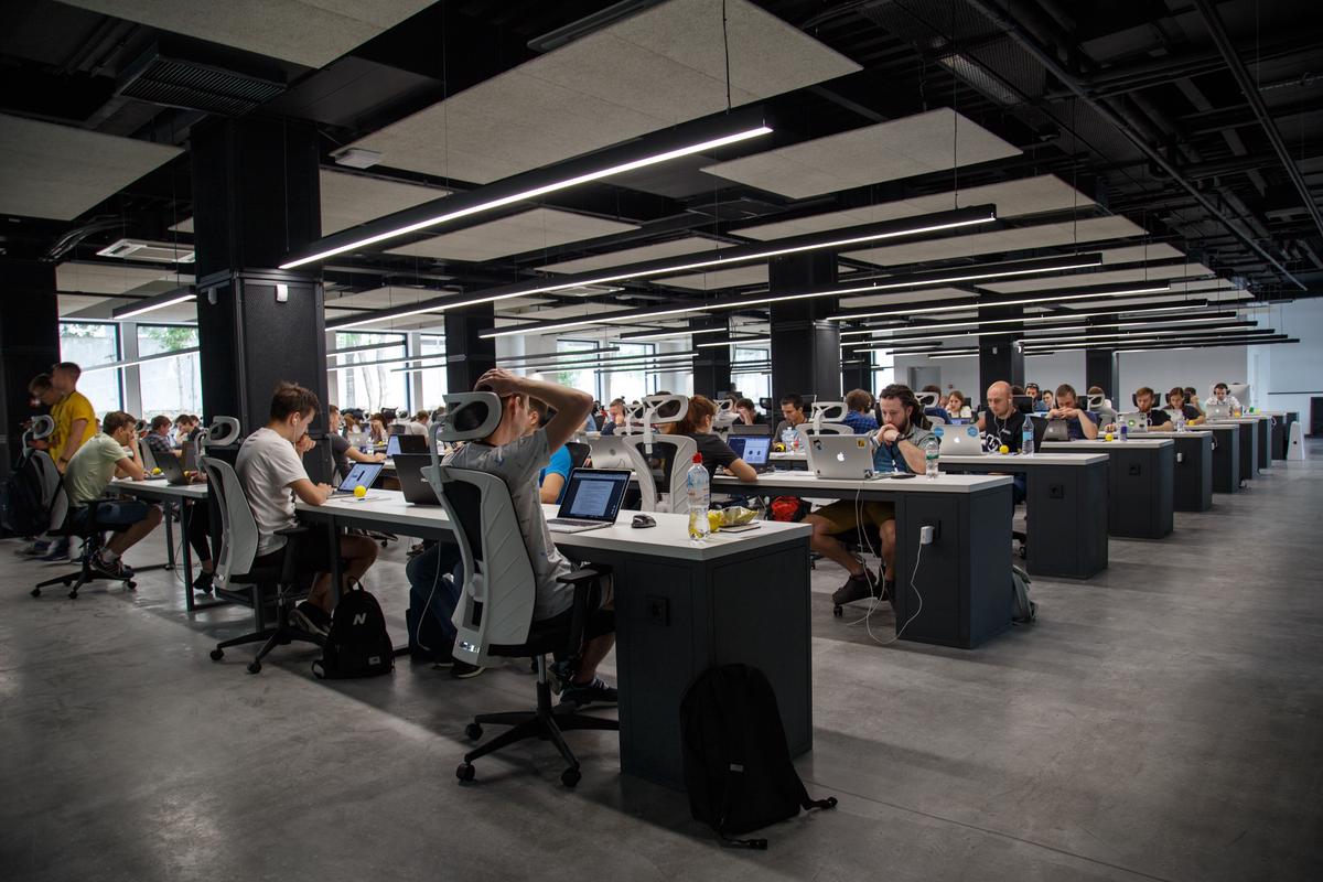 Image of a well-lit office space with employees working happily.